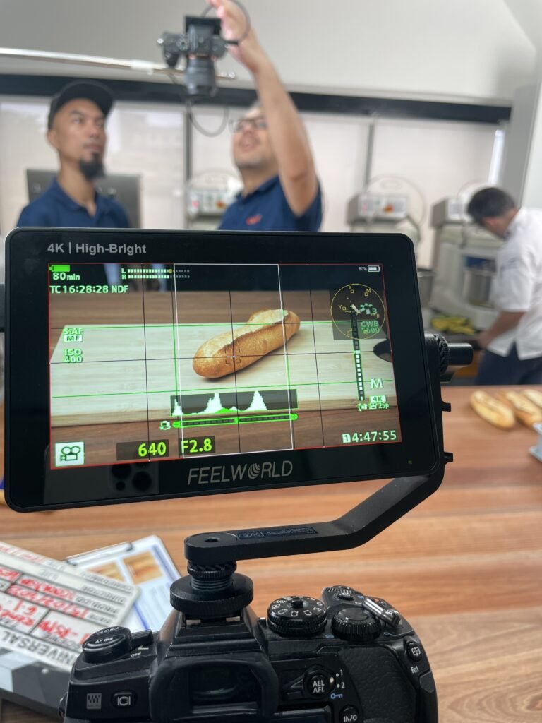 Camera monitor showing a loaf of bread during a food production shoot.