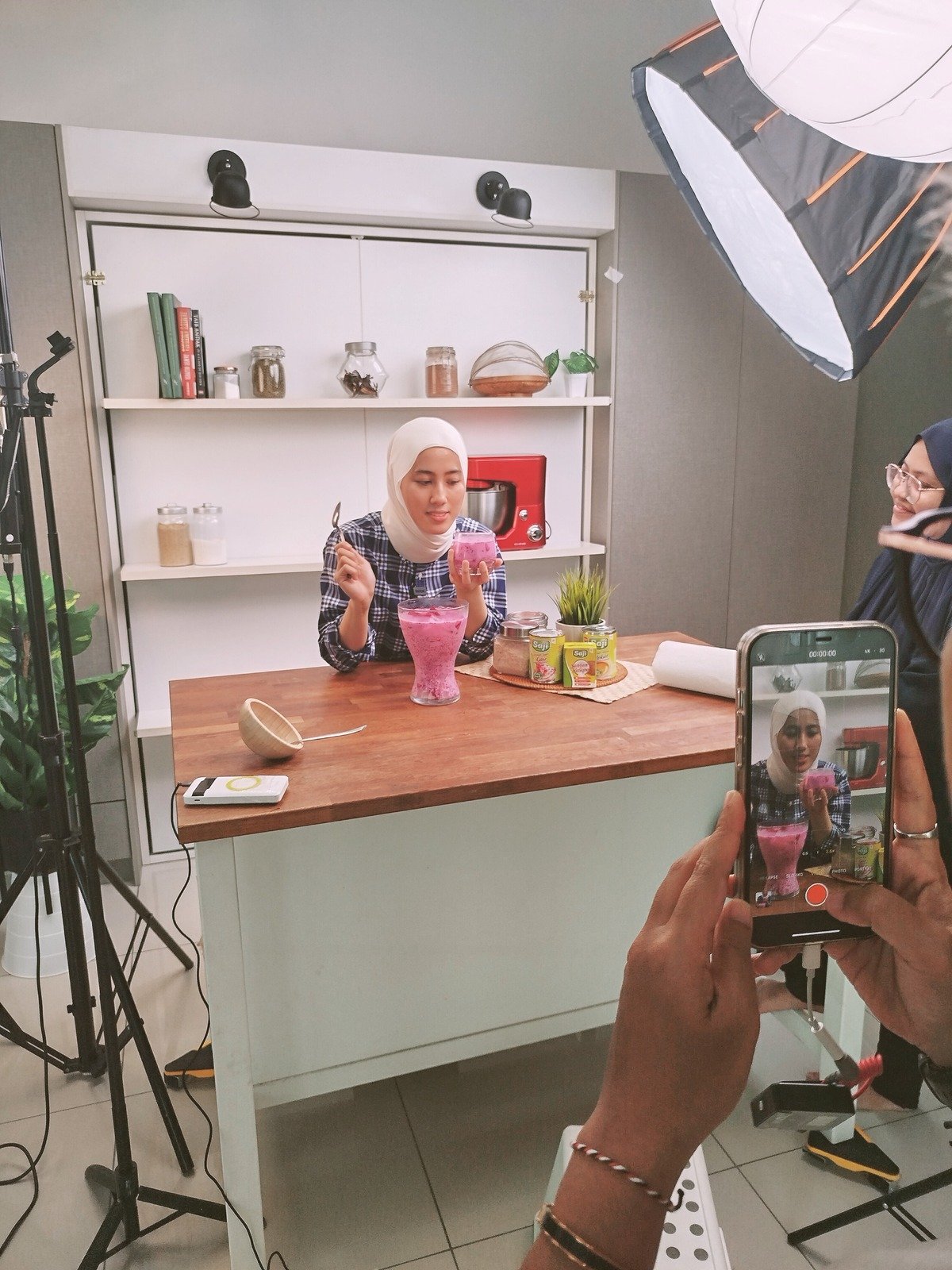 Presenter being filmed on camera in the studio