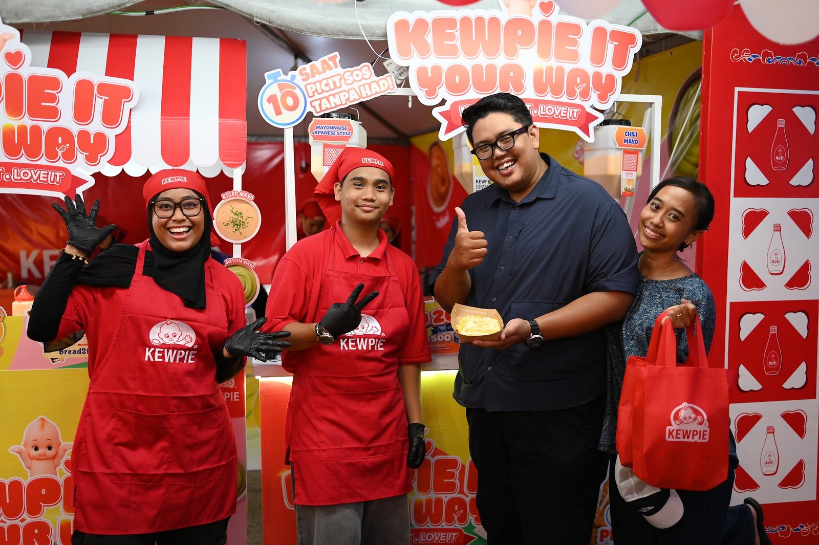 KEWPIE crew serving a sampling portion to a carnival visitor