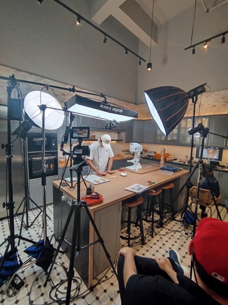 iCookAsia crew filming a Lesaffre technical video demonstration at the bakery counter